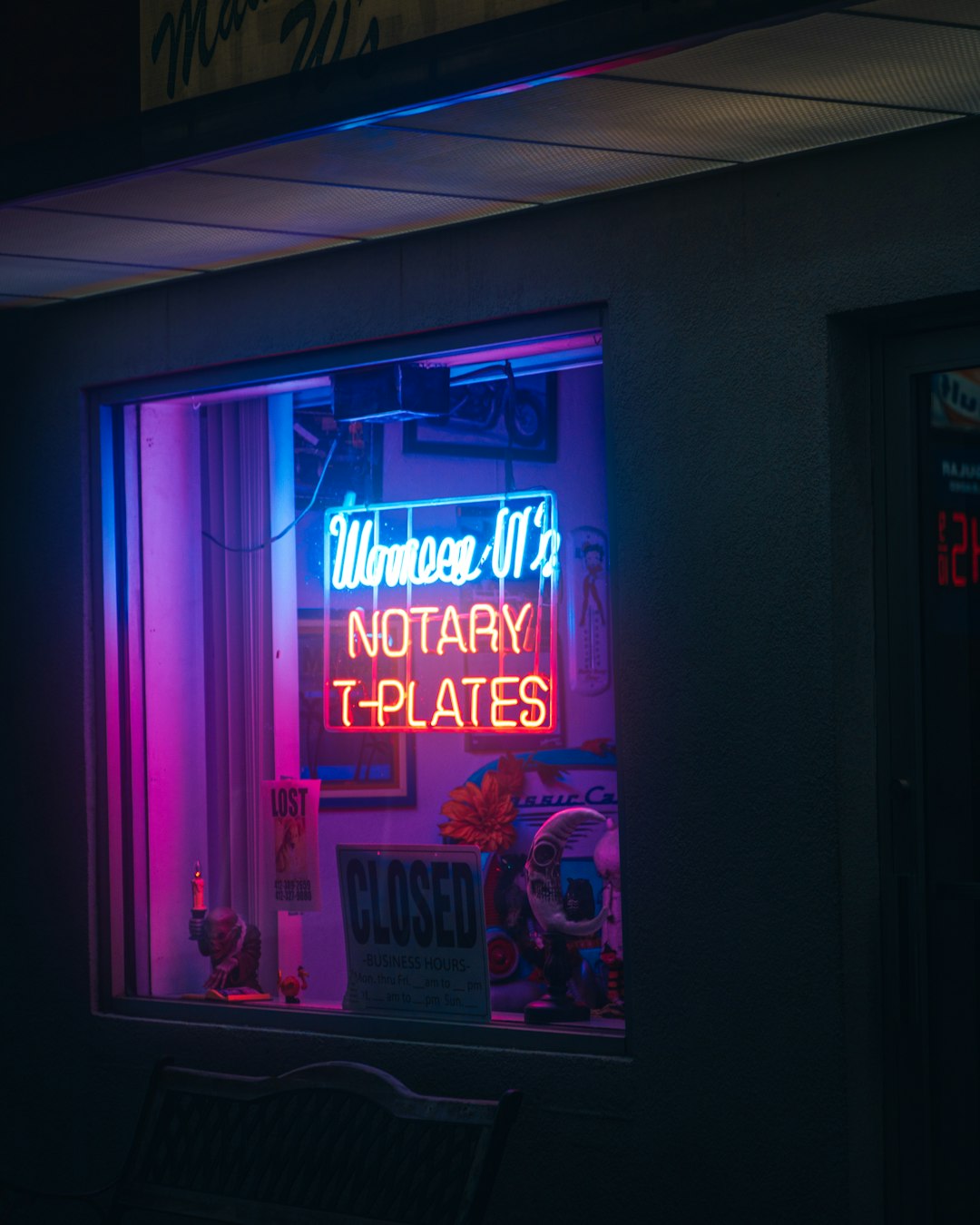a-neon-sign-in-the-window-of-a-store-p-w9aaab3a0